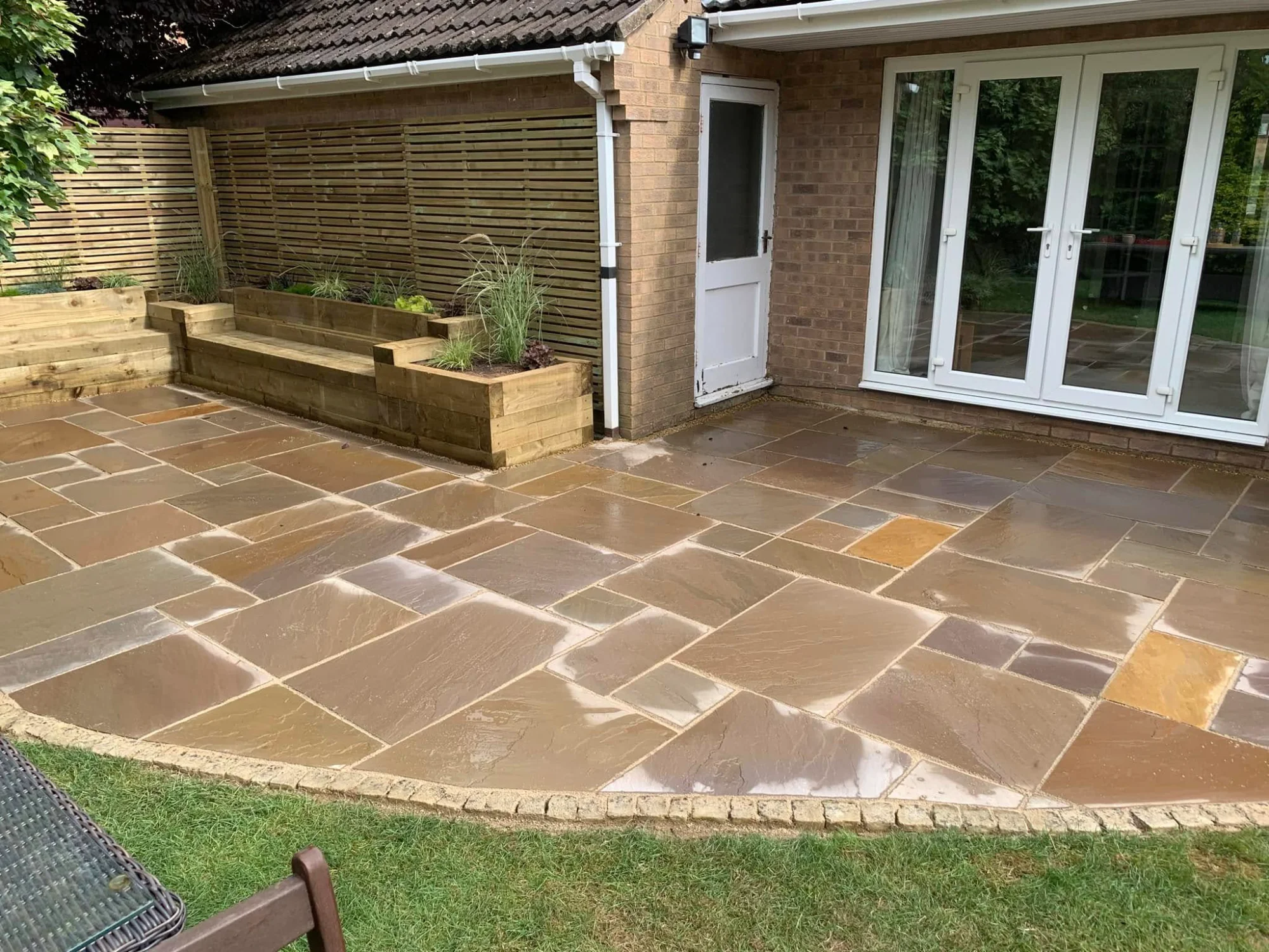 Indian stone patio with quality fencing and lawn